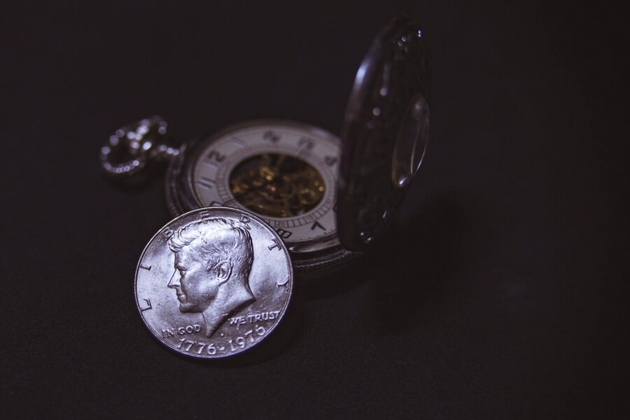 Uhr und Münze aus Silber