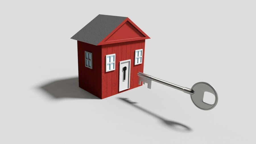 Symbolbild Immobilie - Schlüssel in rotem Haus